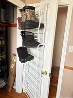 Full view of rack on door with sample boots for scale