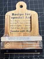Front view of wooden recipe stand showing printed text, acrylic lip and transport stick