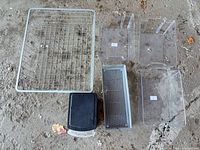 Top-down view showing all primary items: metal wire basket, three clear plastic bins, metal mesh tray, black lidded box