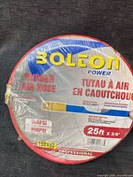 Front view of sealed Bolton Power red rubber air hose showing brand, length, diameter, pressures