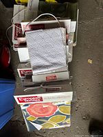 Stack of European Textiles sample books showing bound headers and various swatch colours