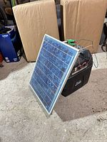 Solar panel leaning against battery box showing overall lot