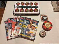 Group shot of entire lot including string lights, magazines, pucks, tin