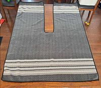 Full view of shawl blanket with contoured slit and stripe pattern