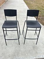 Front view of both bar stools showing overall design and condition