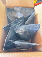 Open carton showing seven black Rishi tea pouches