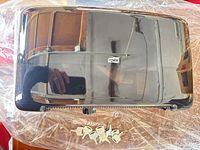 Front exterior of glossy black Tork dispenser with keys shown