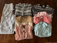 All eight folded garments displayed