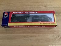 Front view of boxed Life-Like locomotive set through display window