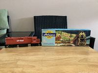 Locomotive beside original box on table