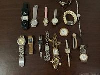 All 15 wristwatches laid out on table