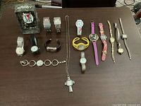 Full lot overview displaying all 16 watches on tabletop