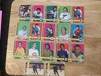 Overview of all 17 1971-72 O-Pee-Chee hockey cards laid out on table