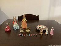 Group shot of all figurines, ashtray, match people on table