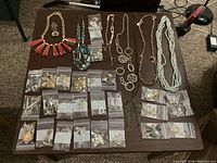 All necklaces and pendant laid out on table