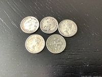 Obverse sides of five dimes