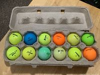 All 12 coloured golf balls in carton