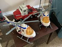 Two helicopters and truck together