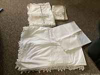 Folded tablecloths and stack of napkins on floor