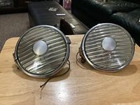 Two round Raydot fog lamps side by side showing overall design and wiring