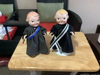 Both Kewpie dolls standing on table, full view