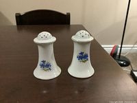 Front view of both shakers showing blue floral decals and overall shape