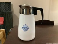 Left side view showing Cornflower motif, handle, collar, lid