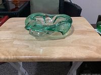 Angled view of green art glass bowl on table