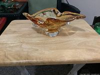 front view of amber art glass dish on table
