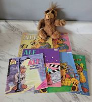 All items displayed—two colouring books, four storybooks, finger puppet