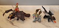 Three dragon figurines, one with mounted knight