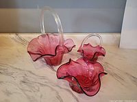 All three cranberry glass items showing form, color, pattern