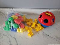 Tupperware Shape-O ball, yellow shape pieces, bag of multicolour Snap-Lock beads
