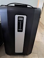 Front view of Haier portable air conditioner showing control panel and exterior condition