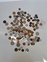 Full spread of assorted coins on white surface