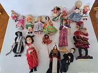 Group shot of all fifteen dolls laid out on white background