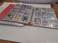 Open binder showing pages of baseball cards