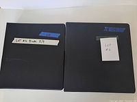 Two closed black binders