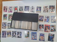 Overview of metal box filled with baseball cards and sample cards laid out
