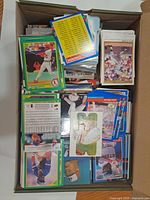 open box filled with assorted baseball cards