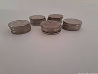Six stacks of Canadian dollar coins, obverse edges visible
