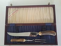 Knife and fork in fitted presentation case, interior cream satin lid, navy base