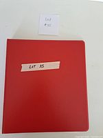 Closed red binder labelled Lot 35