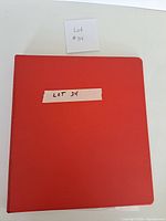 closed red binder labelled Lot 34