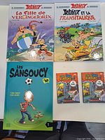 All five French comic books laid out