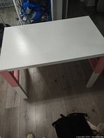 Desk assembled, white top with pink accents and white legs