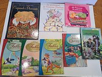 All eight books laid out front covers visible
