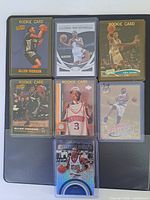 Seven Allen Iverson cards removed from binder for clarity, including multiple rookie cards in sleeves