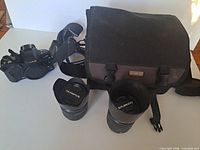 Camera body, both lenses and carrying case overview