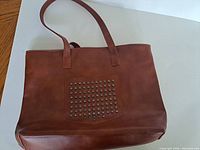 Front view showing studded pocket and straps